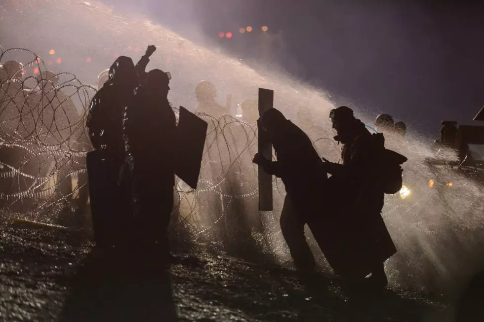 Police fire water cannon at pipeline protesters in freezing weather