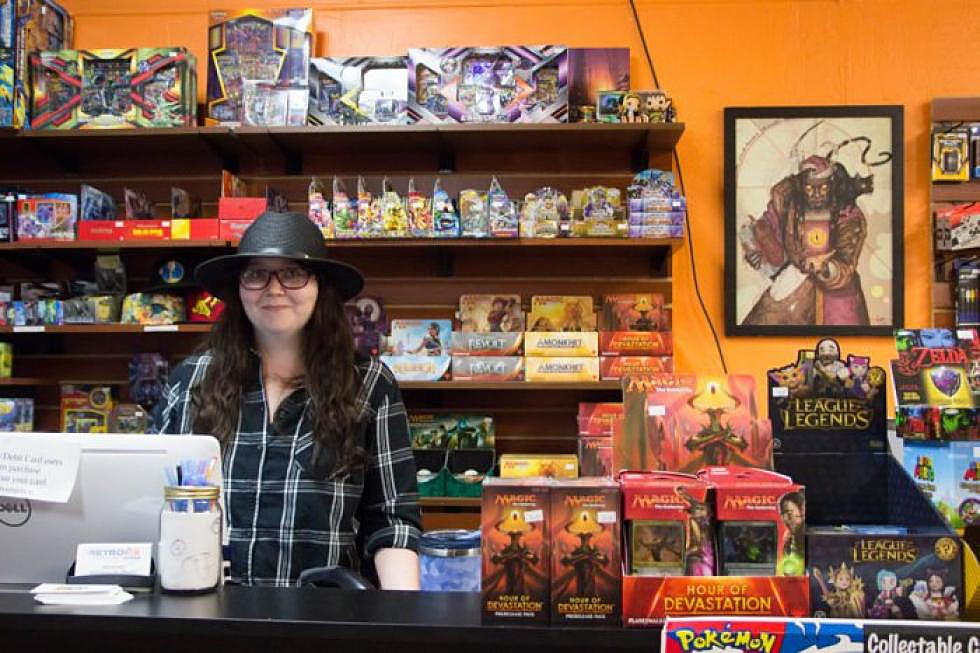 <em>Retrofix employee Hannah Bergman stands among games and paraphernalia at the checkout counter of the store, which is located on Missoula's Hip Strip. (Katy Spence/Missoula Current)</em>