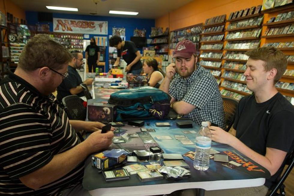 <em>Michael DeBuff, rights, grins as his opponent Charles Overy defeats him in a game of Magic: The Gathering. DeBuff and Overy were playing a warm-up game before participating in Retrofix's weekly Friday Night Magic. (Katy Spence/Missoula Current)</em>