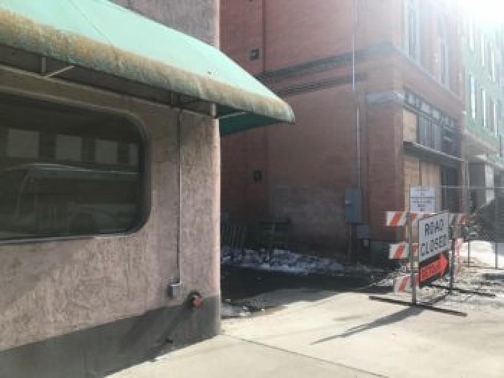 The sun slips over the new Marriott hotel under construction in downtown Missoula and the historic pharmacy building, which was left intact. The new Radius Gallery will replace the former Uptown Diner, pictured with the green canopy.